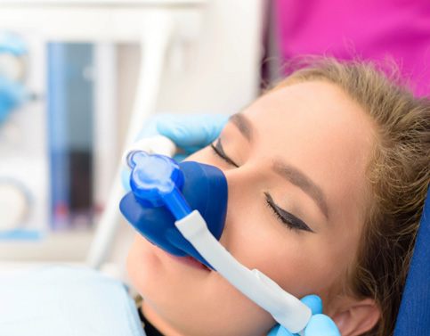 Female dental patient with mask for nitrous oxide sedation in Edison, NJ