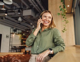 Woman smiling while talking on phone