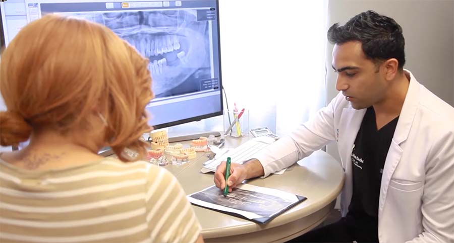 Edison dentist showing a patient X rays of teeth during consultation