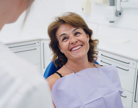 Happy patient smiling at her dentist