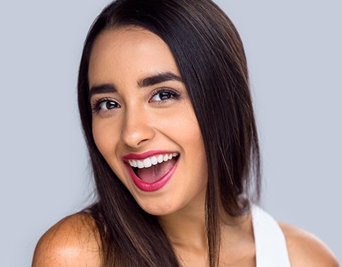 Woman smiling after metal free dental crown placement