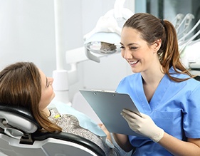 woman smiling while talking to cosmetic dentist in Edison   