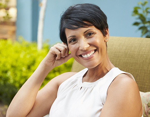 Woman smiling after dental crown restoration