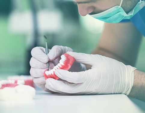 Dental lab technician crafting denture