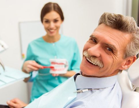 man at a consultation with his denture dentist in Edison, NJ 