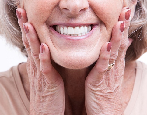 closeup of woman smiling after getting dentures