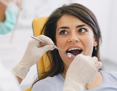 Woman having tooth extracted