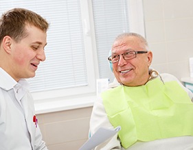 Implant dentist in Edison speaking with a patient