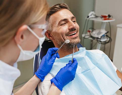 man at a consultation with his dental implant dentist in Edison