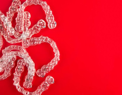 several aligners against red background 