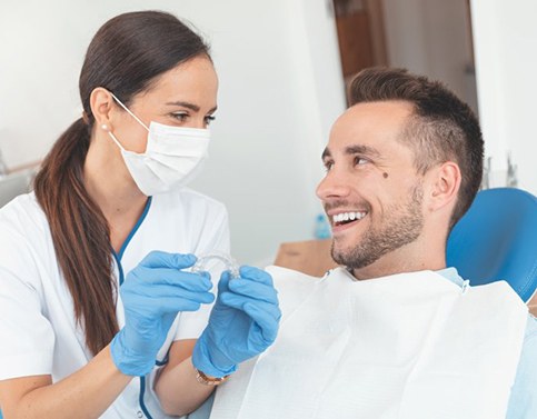 Patient and dentist discussing the cost of Invisalign in Edison 