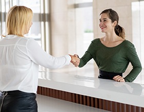 Dentist explaining to patient how to make Invisalign affordable in Edison 