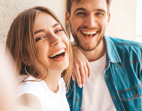 Smiling couple with beautiful teeth after visiting Edison cosmetic dentist