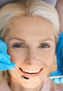 a patient smiling while undergoing dental care