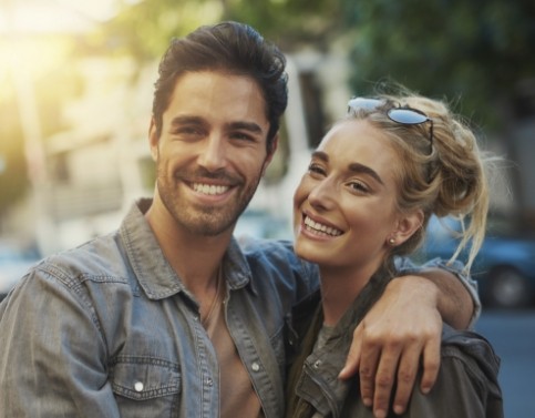 Two people smiling together outdoors