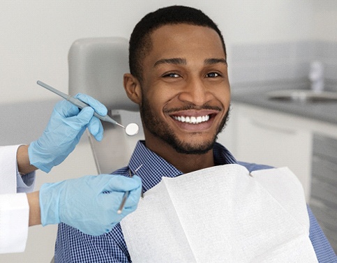 Bearded man smiling after dental appointment