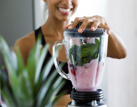 a patient making a smoothie after dental implant surgery