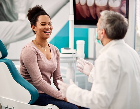 Smiling patient listening to doctor at consultation