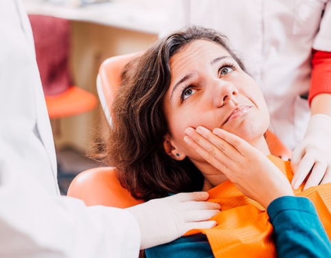 Woman in the dental chair with a toothache