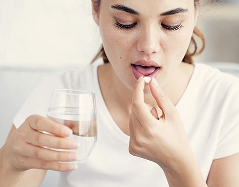 Woman taking oral conscious sedation pill