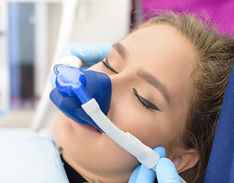 Woman with nitrous oxide dental sedation mask