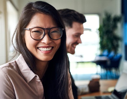 Woman smiling in dental office waiting room