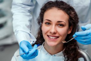 woman with curly hair getting fillings from her dentist in Edison, NJ 