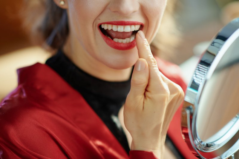 Woman smiling after getting a dental implant