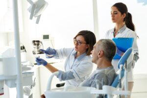 Male patient listening to dentist discuss X-rays and dental crowns